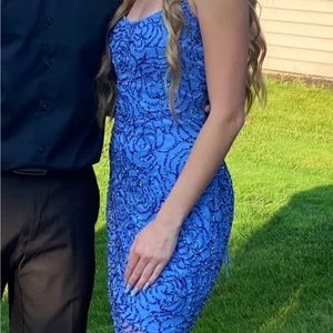 Periwinkle thigh high beaded dress with flower design.